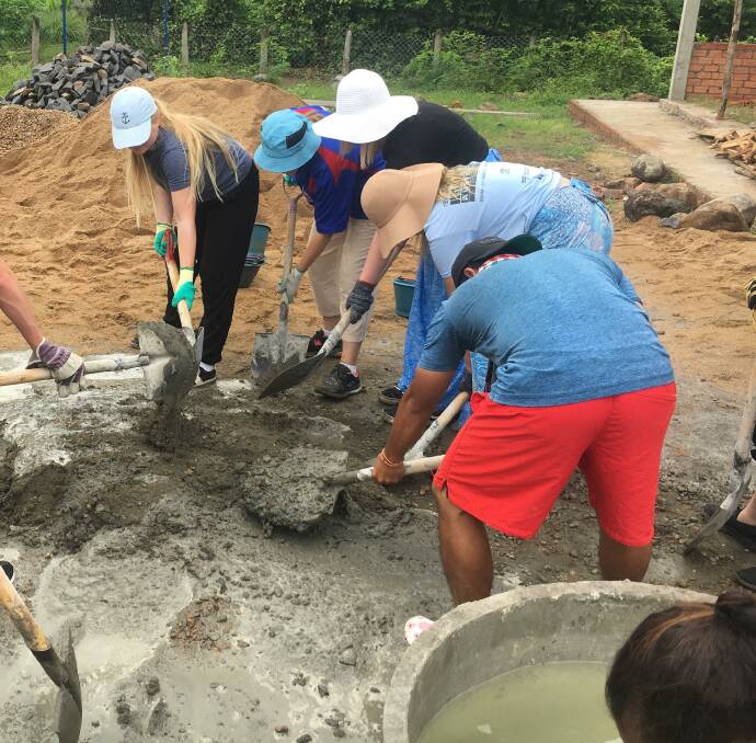 Students dig deep, literally, in Cambodia.