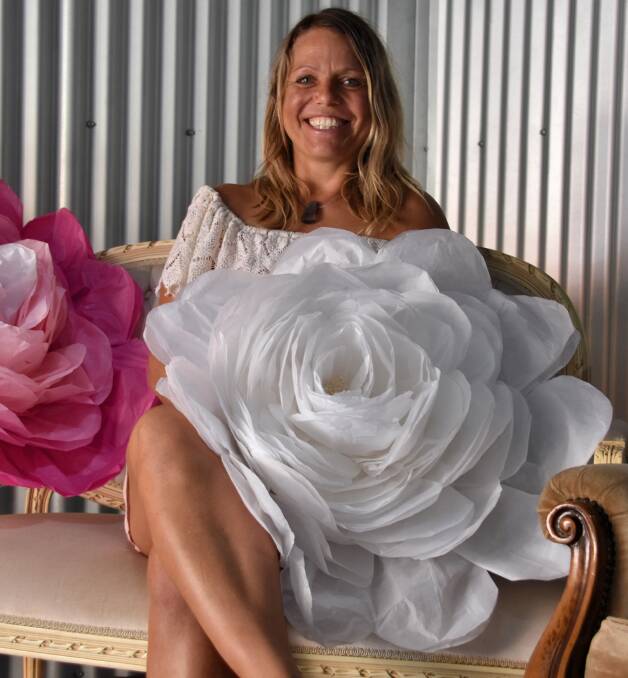 Flowerful: Artist Aloka Canziani poses with some of her unique, hand-made pieces of art. Photo: Matt Attard.