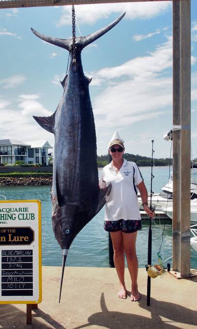 Mammoth haul: Kerryanne Thompson spent over an hour reeling in this 137.2 kilogram blue marlin on Tuesday. Photo: Mike Kane