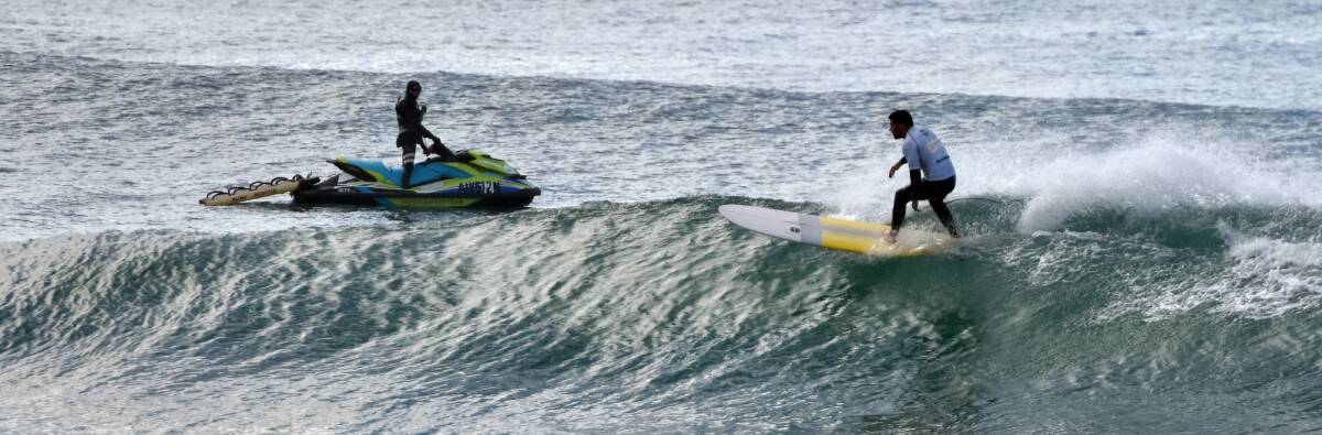 Watchful eye: Grant Ferguson and a safety jet ski during the NSW Longboard Titles on the weekend.