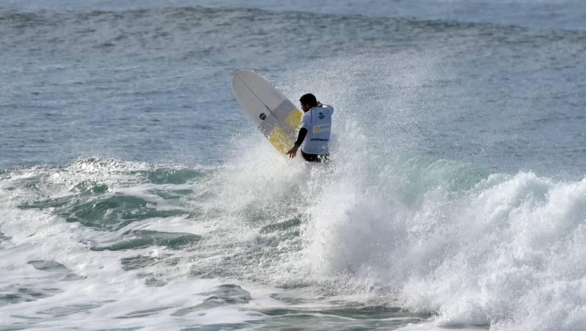 Whitewash: Grant Ferguson submerged in whitewash during the NSW Longboard Titles on the weekend.