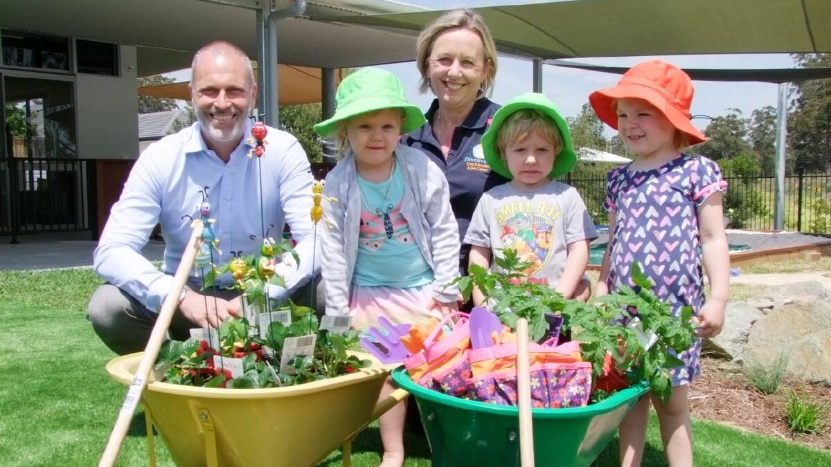 Open for business: Lewis Land Group CEO Chris Calvert with centre owner Kerrie Rowlandson and children (from left) Josie, Thomas and Taylah.