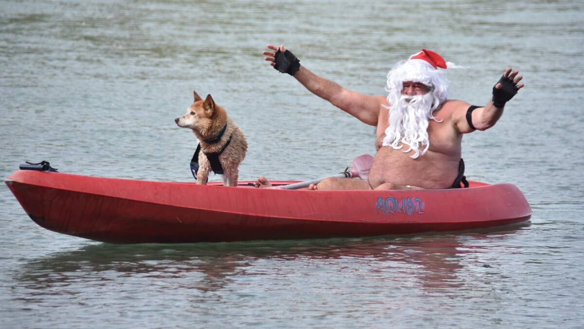 Lake Cathie Santa: Spike and Santa, also known as Ron Hunter, kayaking at Lake Cathie. Photo: Matt Attard