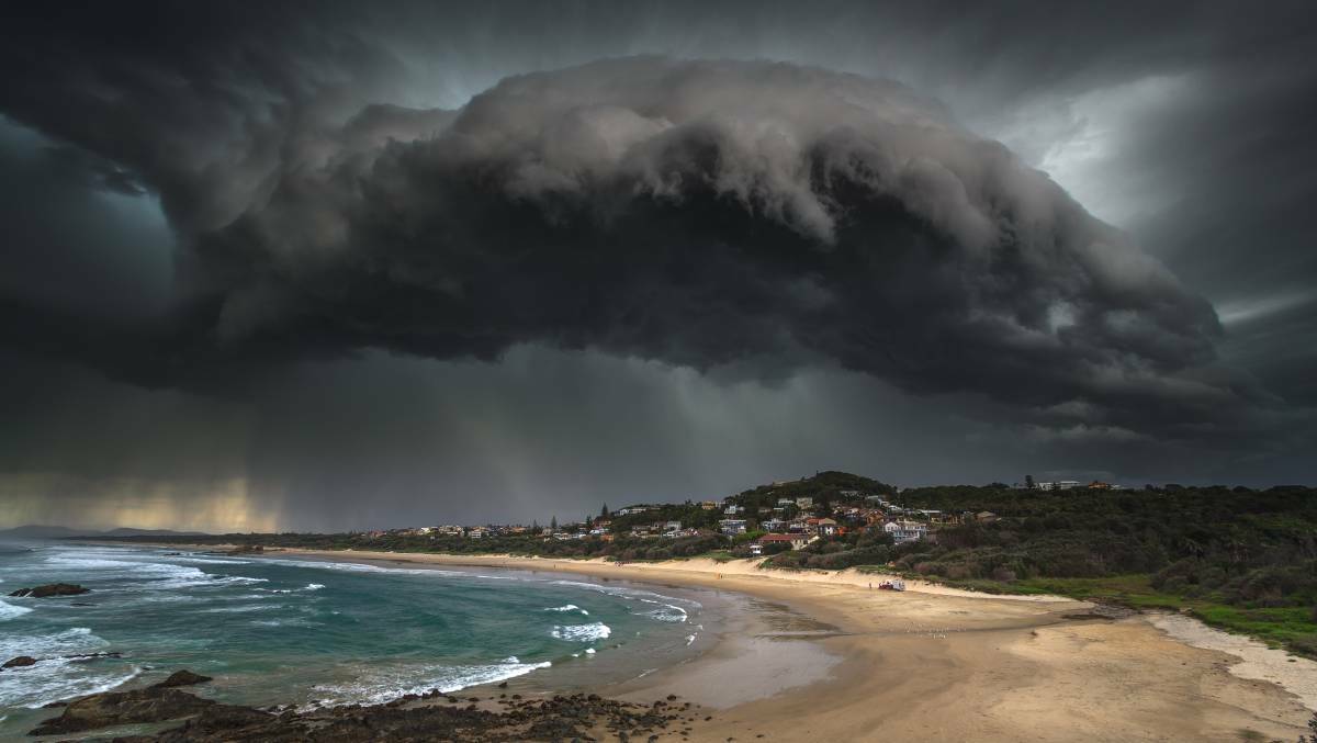 Severe weather: This amazing shot of a thick storm cloud over Lighthouse Beach shows rain falling over Port Macquarie and Bonny Hills in 2017. Photo: Ivan Sajko (Ocean Drive Images)