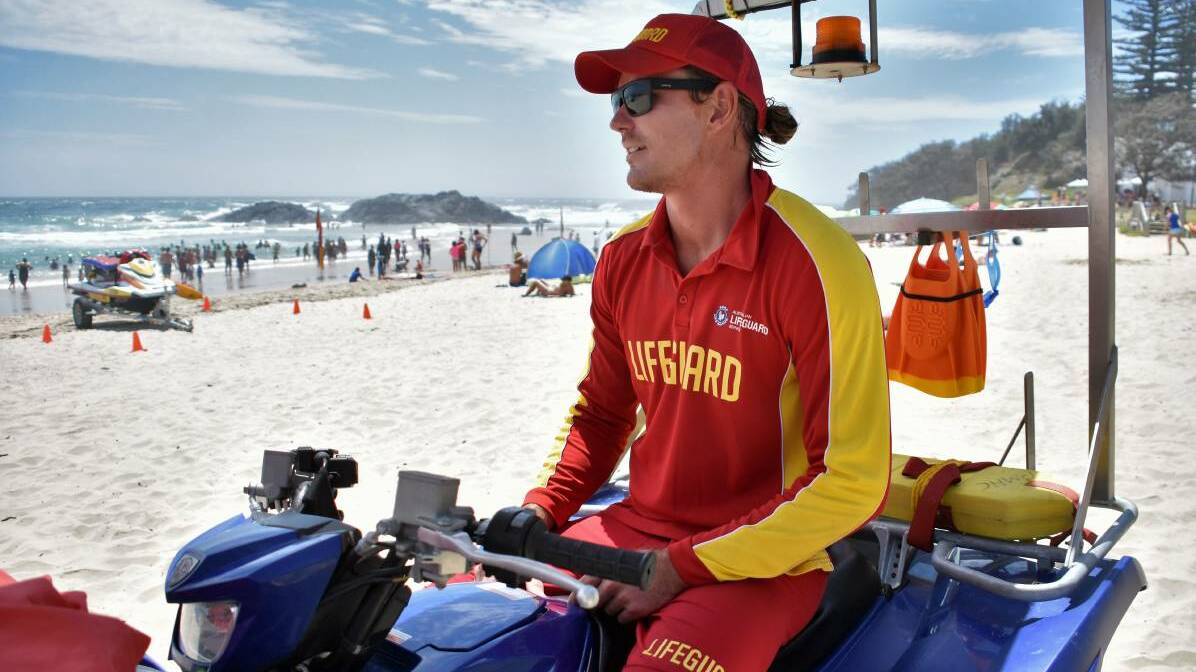 Port Macquarie lifeguard Trent Harrison patrols a busy Towns Beach.