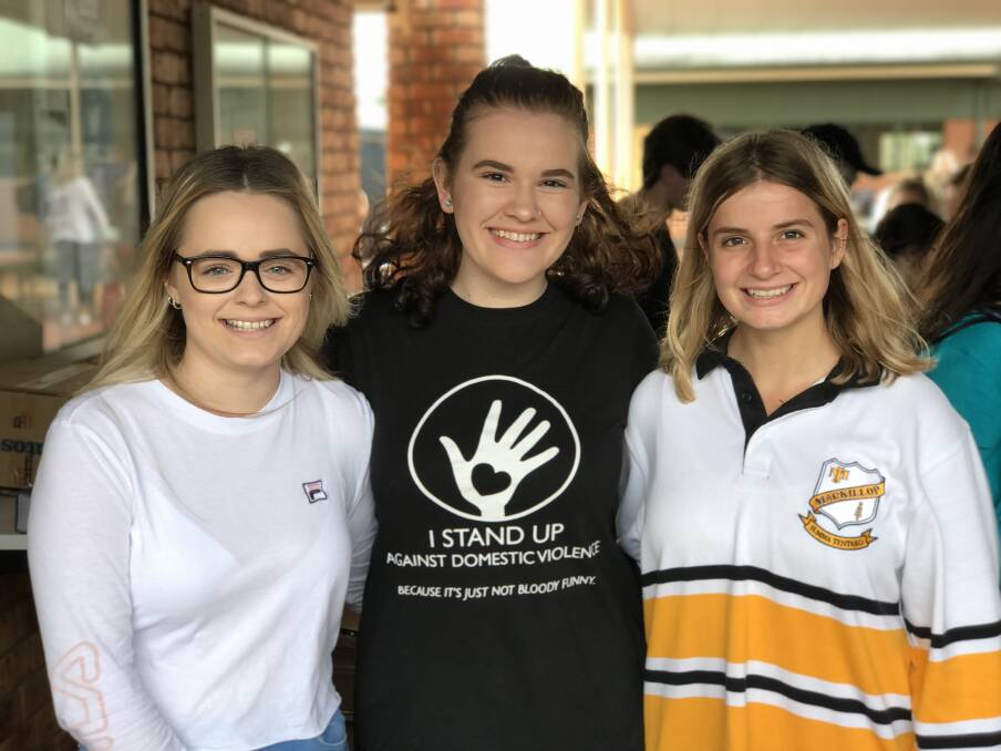 Standing up: Alyssa Pensini, Brooke Denham and Alannah Grose are legal studies students who are currently undertaking the project.