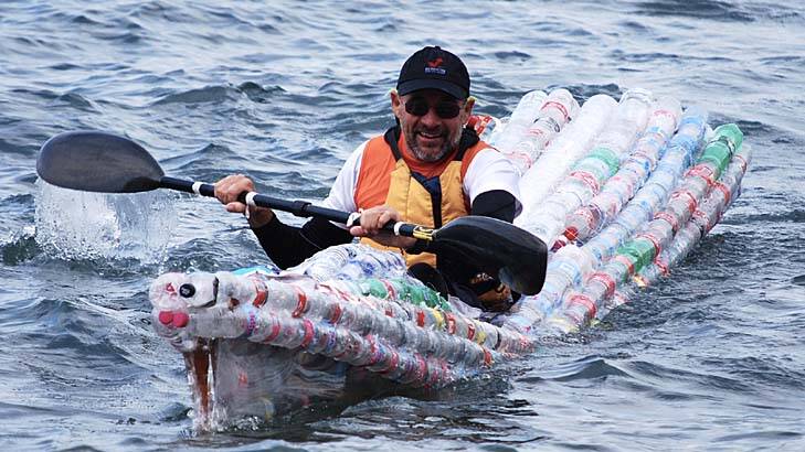 Tom Simmat paddles on the harbour in a boat made of plastic bottles. Photo: Merlin Entertainments