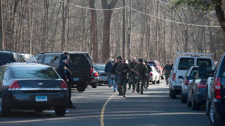 Connecticut State Police walk on Dickson Street from the scene of an elementary school shooting on December 14, 2012 in Newtown, Connecticut. According to reports, there are more than 20 dead, most children, after a gunman opened fire in at the Sandy Hook Elementary School. The shooter was also killed.