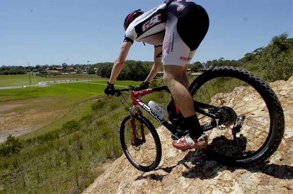 Conquering ‘the rock’: Jason English tries one of the more difficult features of the proposed mountain biking track at Wayne Richards Park.  Pic:NIGEL McNEIL