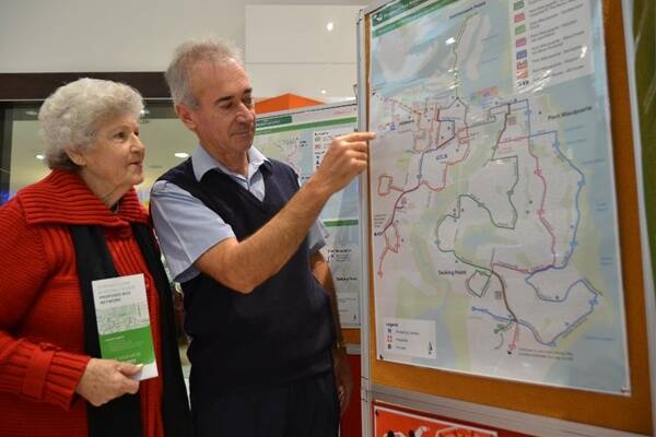 Bus routes: Wayne Hopwood shows Betty Saunders the new bus route for Port Macquarie.