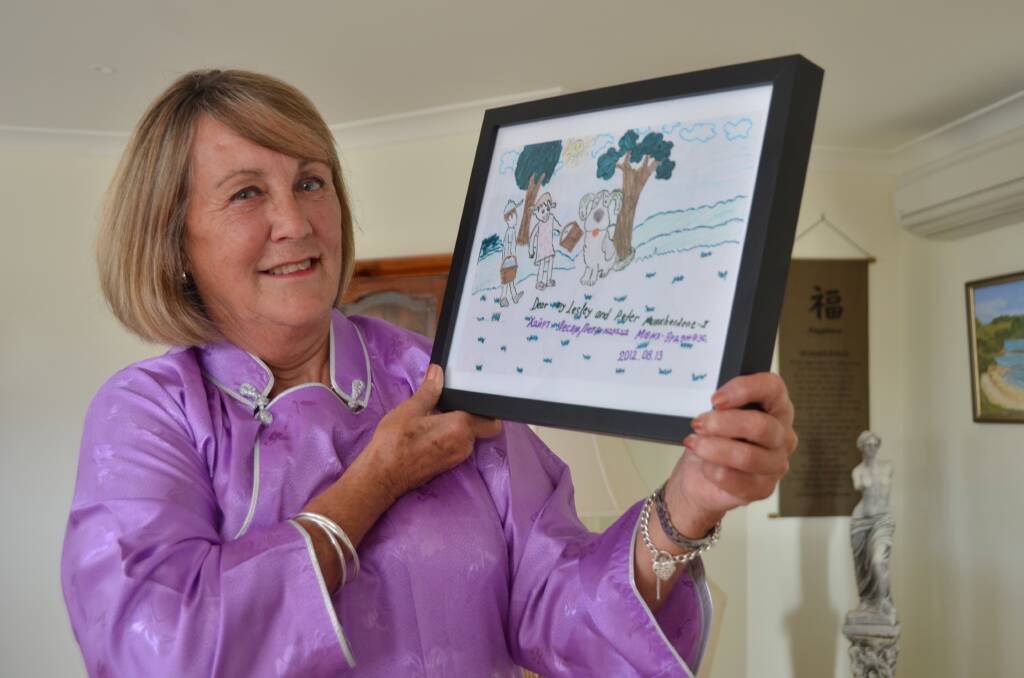 Great memories: Lesley O'Mara wears a traditional Mongolian costume as she holds a drawing created by Munkherdene.