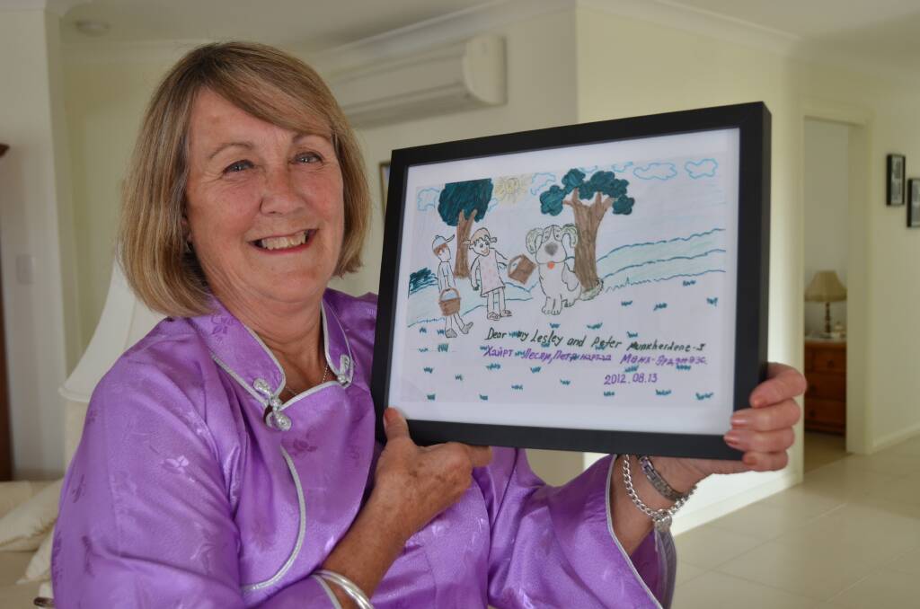 Great memories: Lesley O'Mara wears a traditional Mongolian costume as she holds a drawing created by Munkherdene.