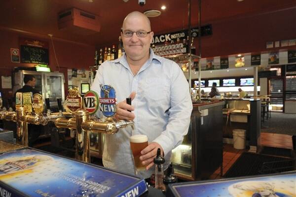 Beer business: Tacking Point Tavern licensee Phill Cardwell pulling a beer ...  he expects to keep pulling them.