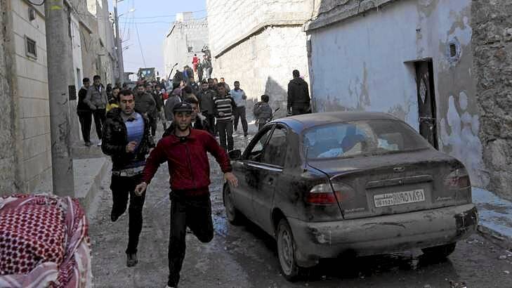 Residents flee an air strike by a fighter jet loyal to Syrian President Bashar al-Assad in Aleppo's al-Marja district on Monday. An Australian has been reportedly killed in the ongoing civil war.