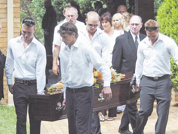 Farewell: Pallbearers carry Mitch Voysey’s casket at Innes Gardens Memorial Park chapel yesterday.