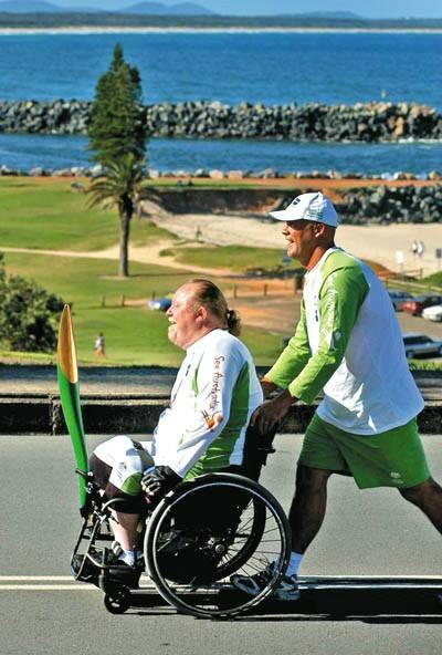 Tom Kennedy takes the Melbourne 2006 Queen's Baton through Port Macquarie with escort runner Martin Dures.