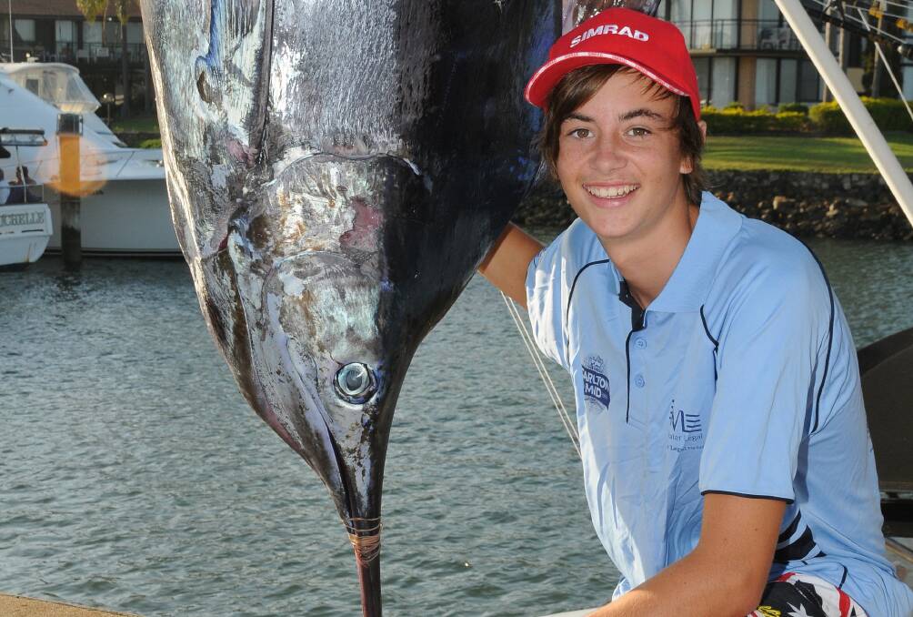A whopper: 15-year-old junior Kurtis Necelli  from Port Macquarie with his 144.4kg Blue Marlin caught with 37kg line aboard Shotgun. Pic: PETER GLEESON
