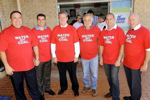  NSW Premier Barry O’Farrell, NSW Energy Minister   Chris Hartcher and other Liberal-National Party MPs fronting the cameras   wearing ‘Water before Coal’ T-shirts.