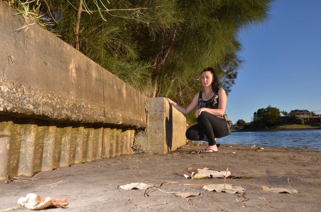 Plea for action: Madison Kirby is part of a group of locals worried about the  danger of exposed asbestos forming part of a canal  revetment wall near Settlement City. 