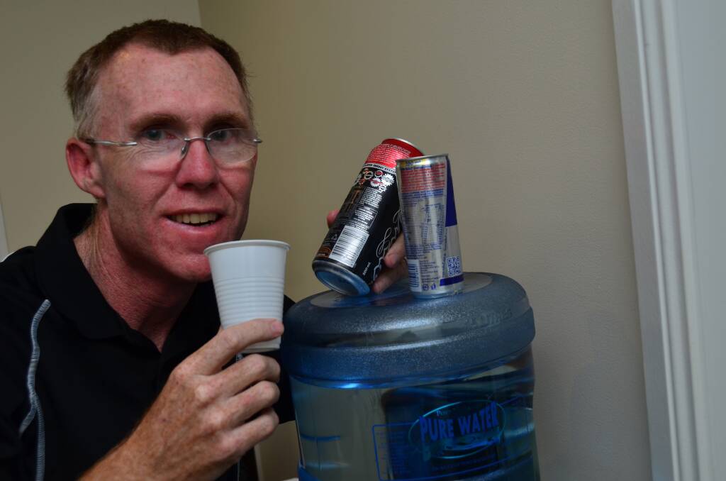 Make the right choice: Local dietician Peter Clark with energy drinks and water. He says the new family-sized drinks are high in sugar and caffeine and will increase risks associated with he drinks.
