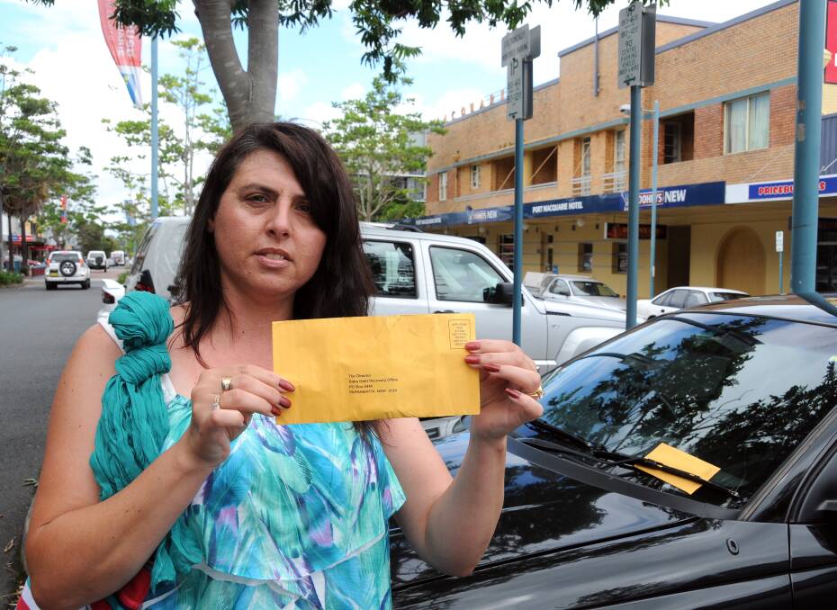 Cranky tourist: Linda Balogh holds her parking ticket near the space she overstayed last week. Meanwhile, another car was stung with a ticket as she spoke to Port News.