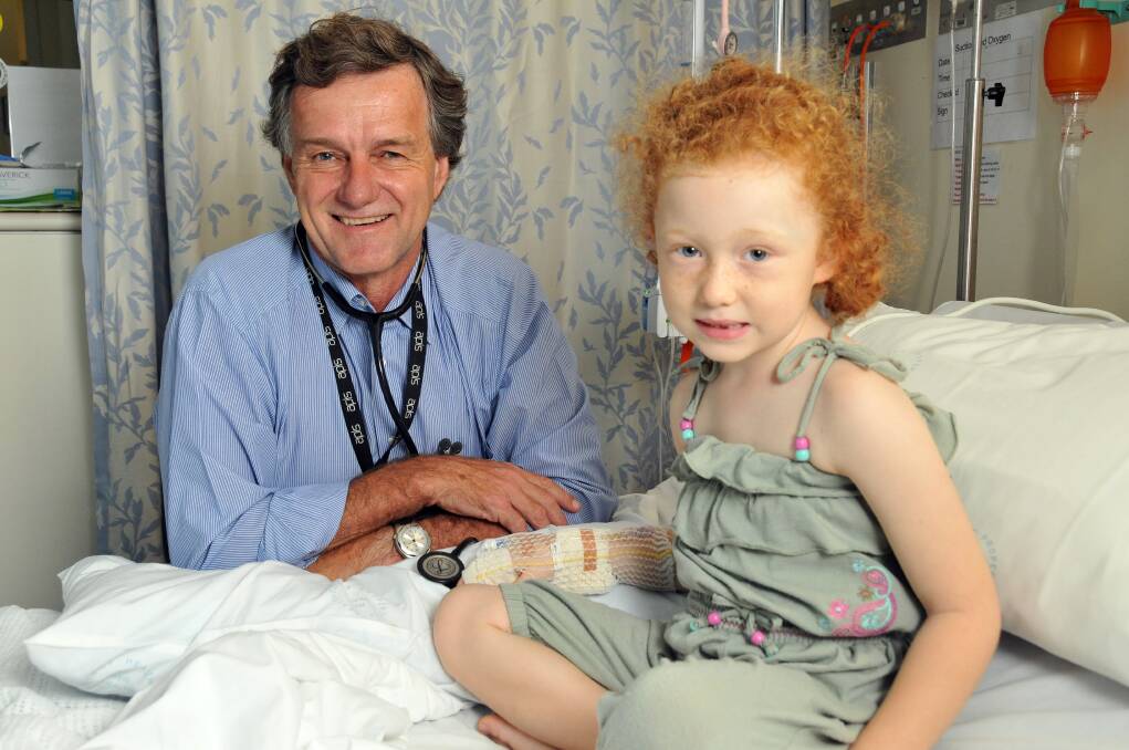 Dr David McDonald examines young patient Siena Crisafi at Port Macquarie Base Hospital.