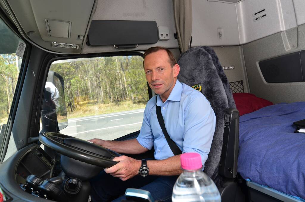 On the road: Federal Opposition Leader Tony Abbott behind the wheel of a truck on the Pacific Highway near Port Macquarie yesterday. 