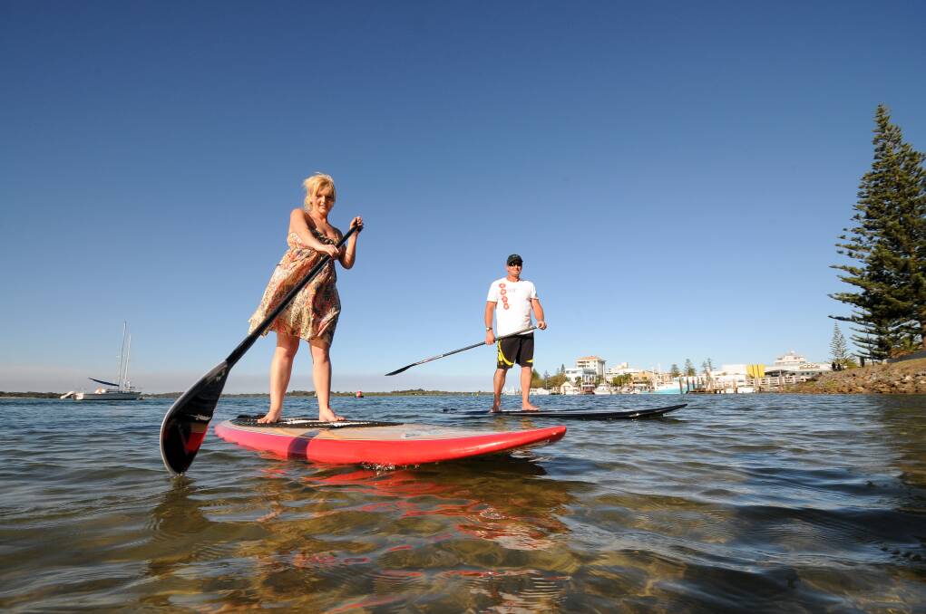 Paddle safe: Liz Martin and Wayne Dean from Stand Up Paddle Port Macquarie enjoying an afternoon on the water.