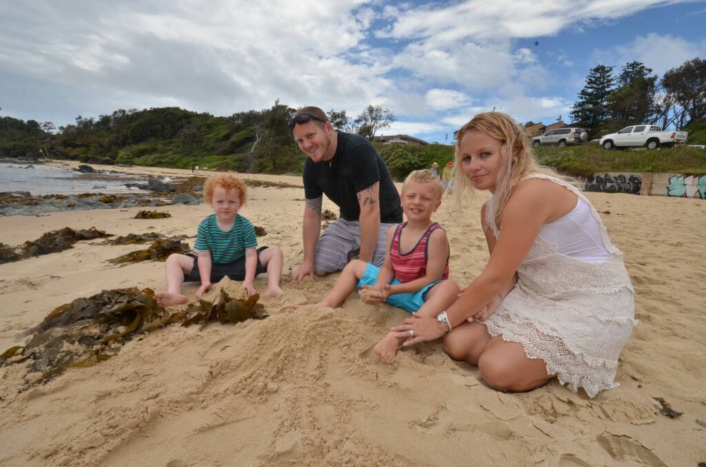 Syringe shock: Shani Southwell who found a syringe on Flynns Beach earler this week while walking along the sand with her husband Jay and children Kaiden and Zavier.