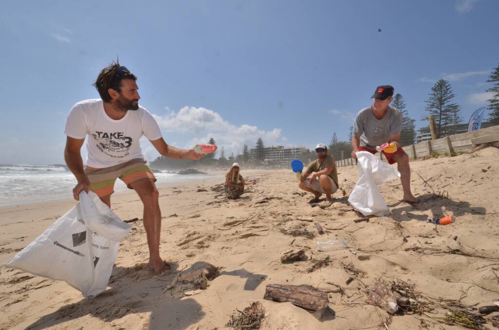 Making a difference: Environmentalist and Take 3 co-founder Tim Silverwood, volunteer Anna Weatherstone, Adrian Midwood from Ocean Ambassadors and Leisure Activist Group operations manager, and Ivan MacFadyen pick up rubbish from Town Beach.