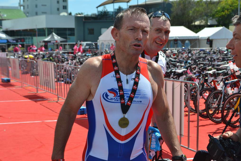 The Nationals have confirmed Prime Minister Tony Abbott attended a two-hour soirée during his controversial taxpayer funded trip to Port Macquarie in 2011. Pictured is Mr Abbott after finishing the bike-leg of the 2011 70.3 Ironman in Port Macquarie. PHOTO: Port Macquarie News.
