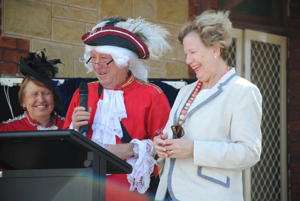 Peter Connolly and Liz Scarce cope with the blustery wind at Tailem Bend Railway Station's centenary celebration. PHOTO: Murray Valley Standard.