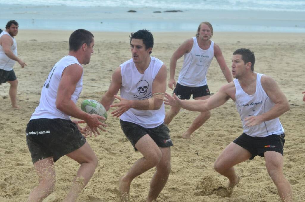 Beach rugby hits the sand, soggy as it was.