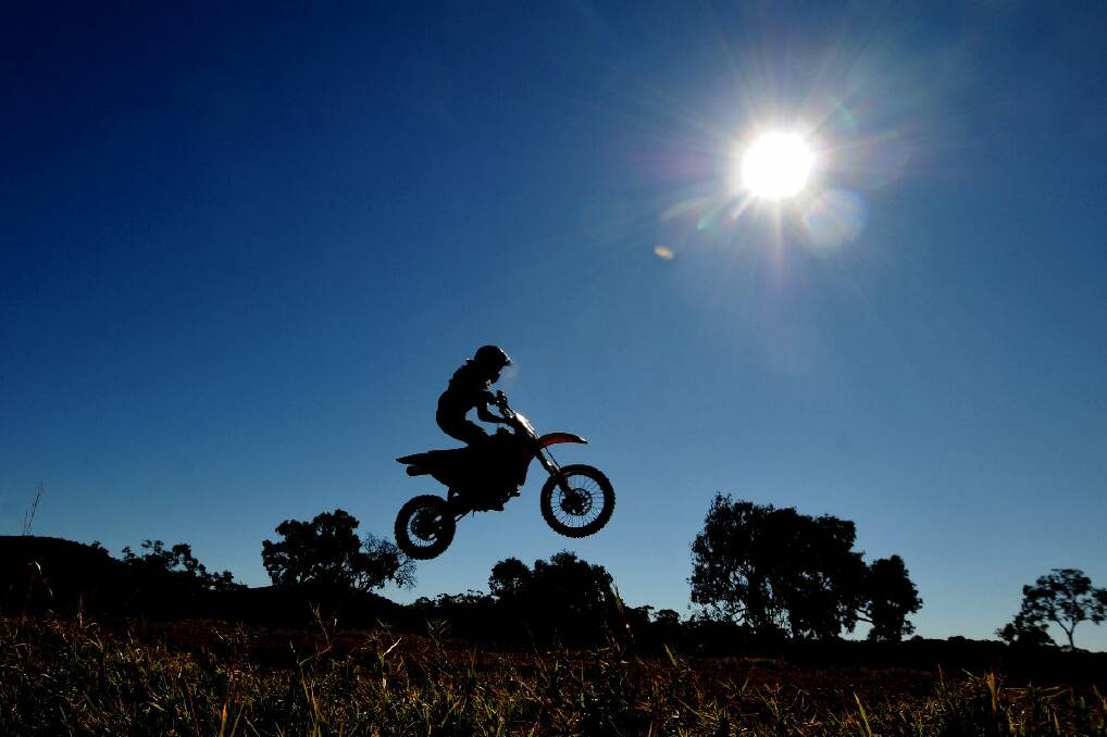 On a hot weekend afternoon, the sun was out in full force as motocross riders faced the track. For this photo, I was laying on the side of the table-top jump with a wide angle lens, hoping to catch a rider in sillouhette as they soared over the ramp. Pic: MATT ATTARD