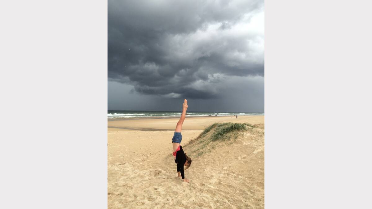 Maya Mackenzie, 12, provides the exclamation mark for the clouds at Lighthouse Beach. Pic: Don Mackenzie