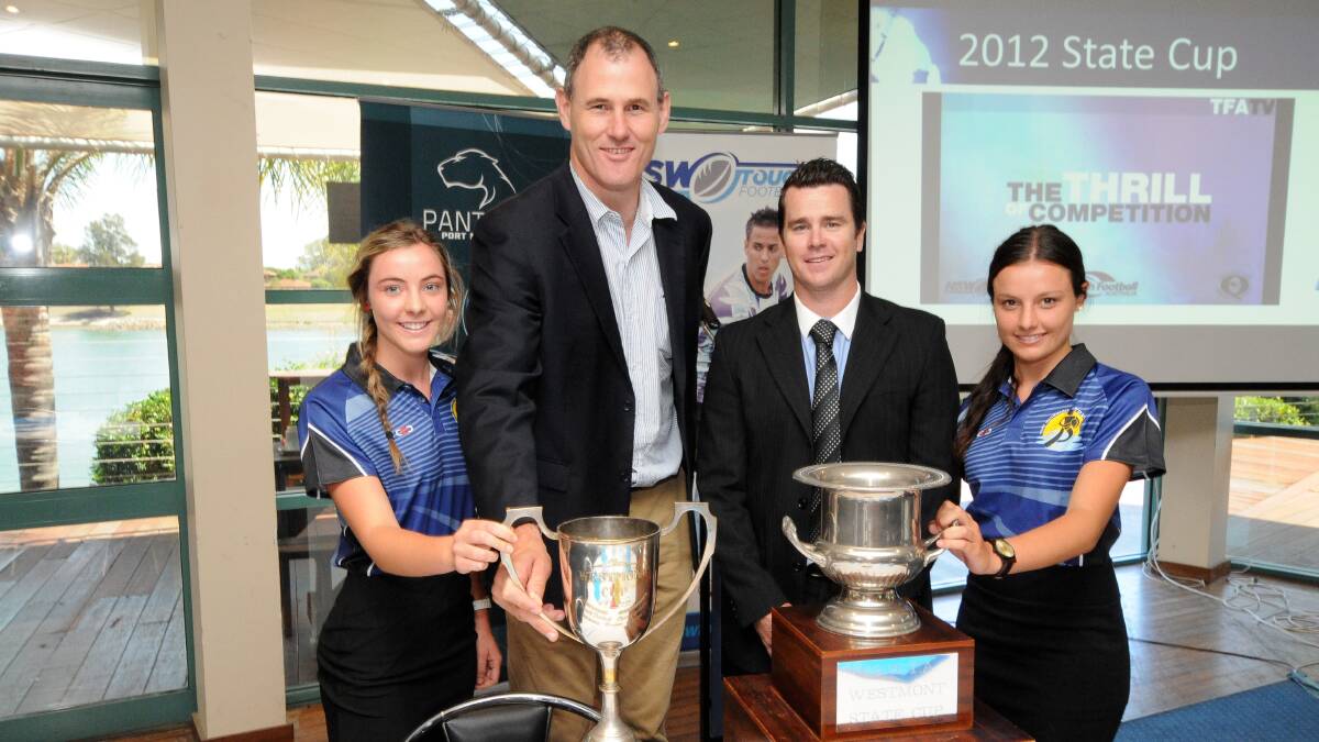 Silverware: Port Macquarie women's open player Laura Coleman, Port Macquarie-Hastings mayor Peter Besseling, NSW Touch Football sport manager Daniel Rushworth and Port Macquarie open women's player Kate Coleman with some of the trophies on offer at the launch yesterday.