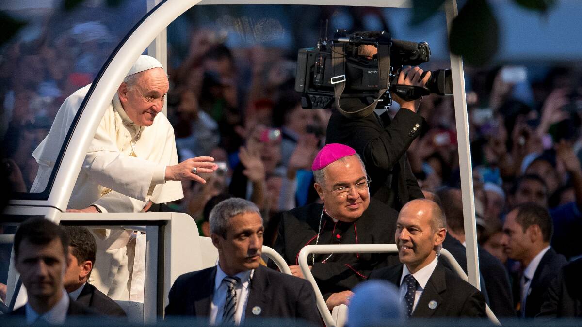 Pope Francis waves from the Popemobile on his way to attend the Via Crucis on Copacabana Beach during World Youth Day celebrations in Rio de Janeiro, Brazil. Photo: Getty Images