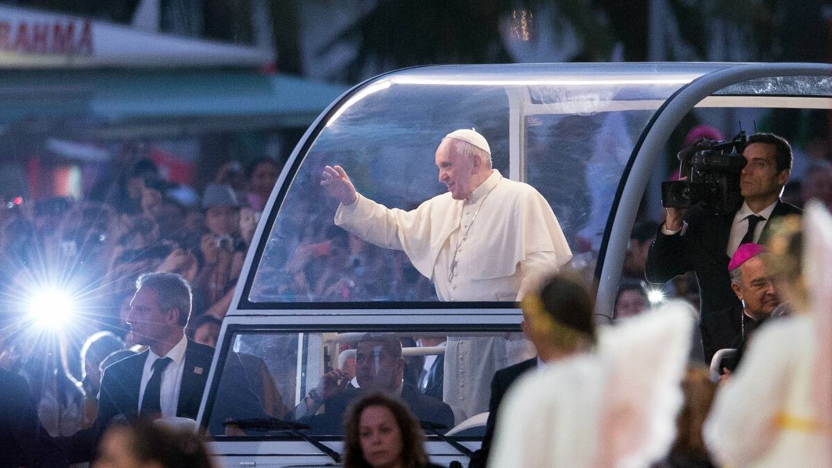 Pope Francis waves from the Popemobile on his way to attend the Via Crucis on Copacabana Beach during World Youth Day celebrations in Rio de Janeiro, Brazil. Photo: Getty Images 