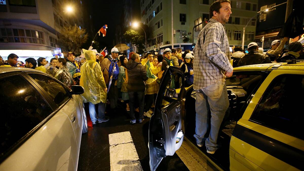  A taxi driver assesses the scene as people crowd the streets blocking traffic following Pope Francis' Mass on Copacabana Beach on July 25. Photo: Getty Images