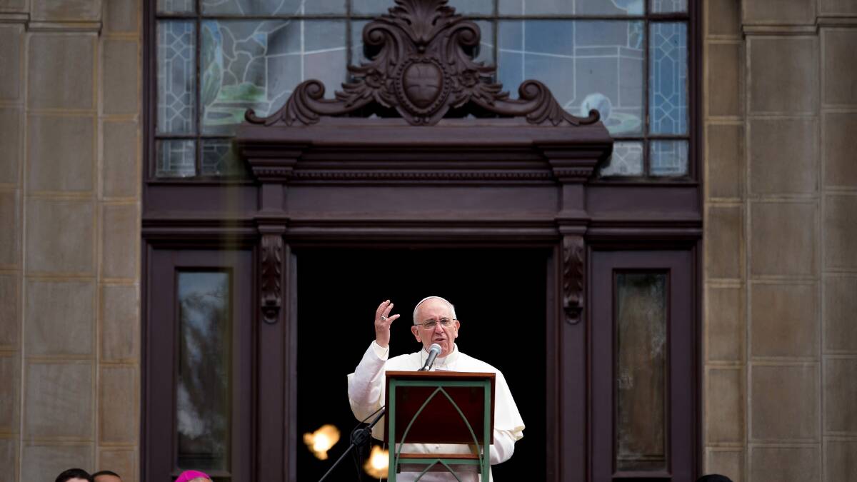 Pope Francis waves to the crowd from a balcony of the San Joaquin Episcopal Palace. Photo: Getty Images