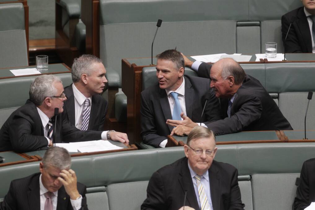 Independent MPs Andrew Wilkie Craig Thomson Rob Oakeshott and Tony Windsor talk during the motion if no confidence during question time at Parliament House in Canberra. Photo: Fairfax Media