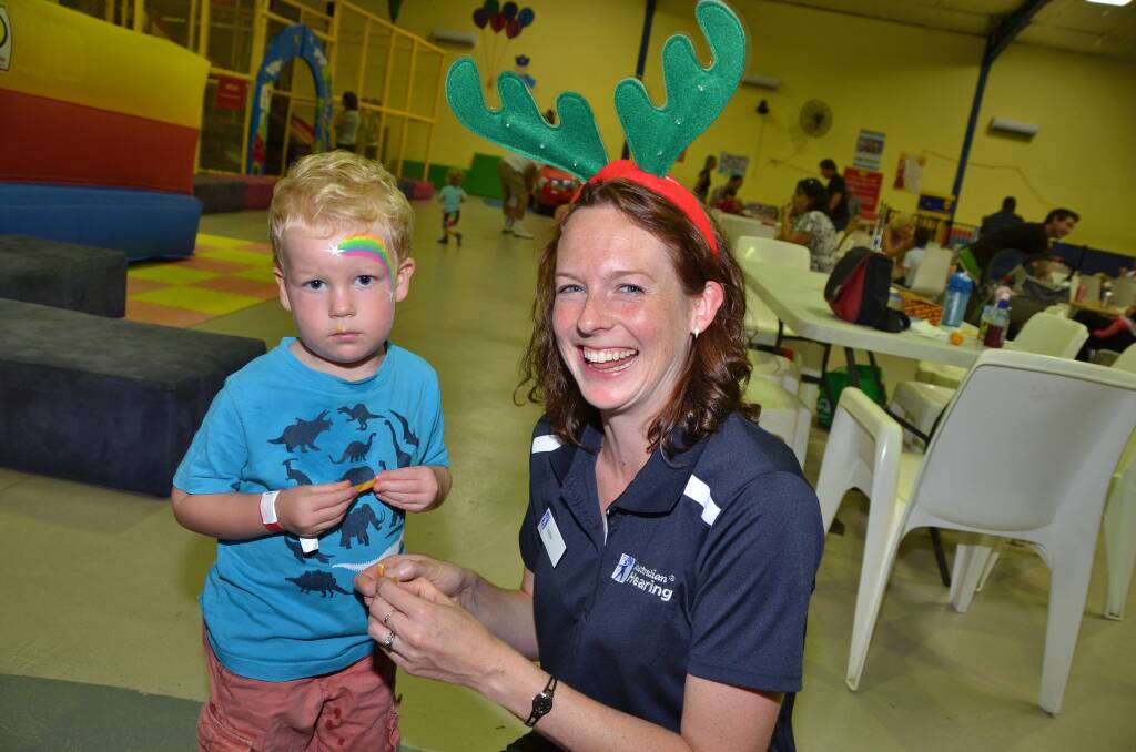 Darcy and Louise Every about to tuck into a candy cane at Jumbos Playland during the Australian Hearing Port Macquarie Christmas party. Photo:Port News