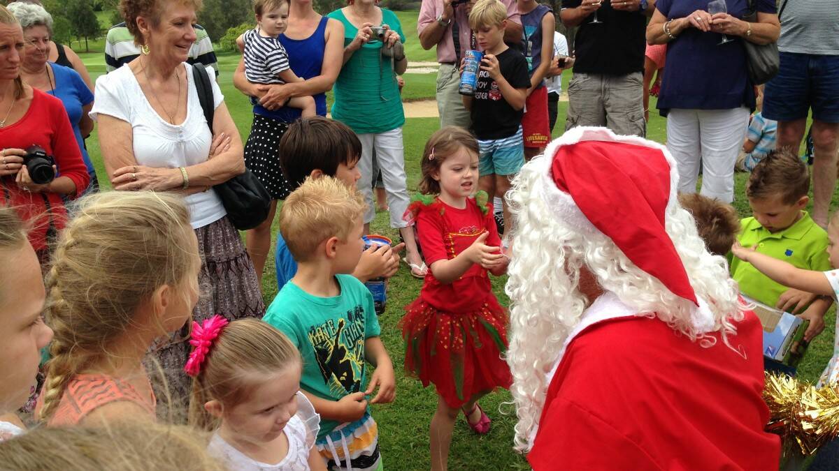 Kew Country Club kids Christmas party saw Santa arrive on the golf course in a helicopter, hand out presents to members' children and hear their Christmas wishes. Thanks to John Parrot and helicopter pilot Grant Burley for donating their time for the kids. Photo: The Camden Haven Courier.