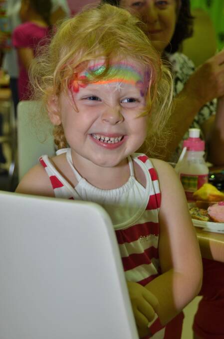 Chelsea Bollard is all smiles after getting her face painted at Jumbos Playland during the Australian Hearing Port Macquarie Christmas party. Photo:Port News