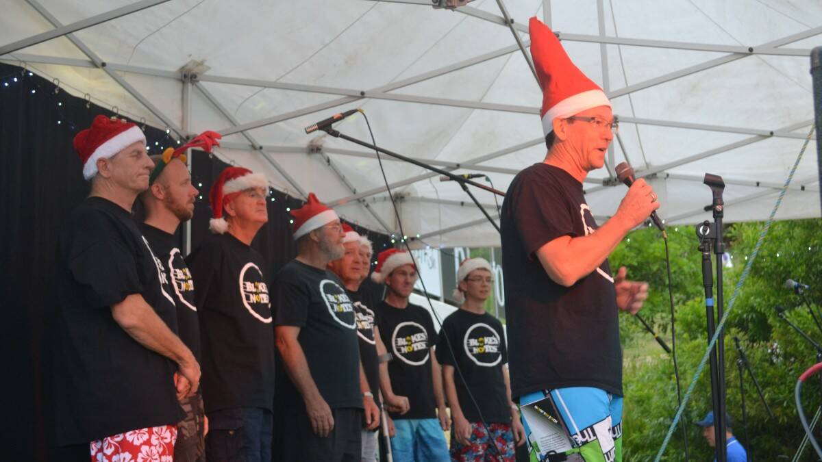 The Blokes Notes choir on stage at carols on the Deck. Photo: The Camden Haven Courier. 