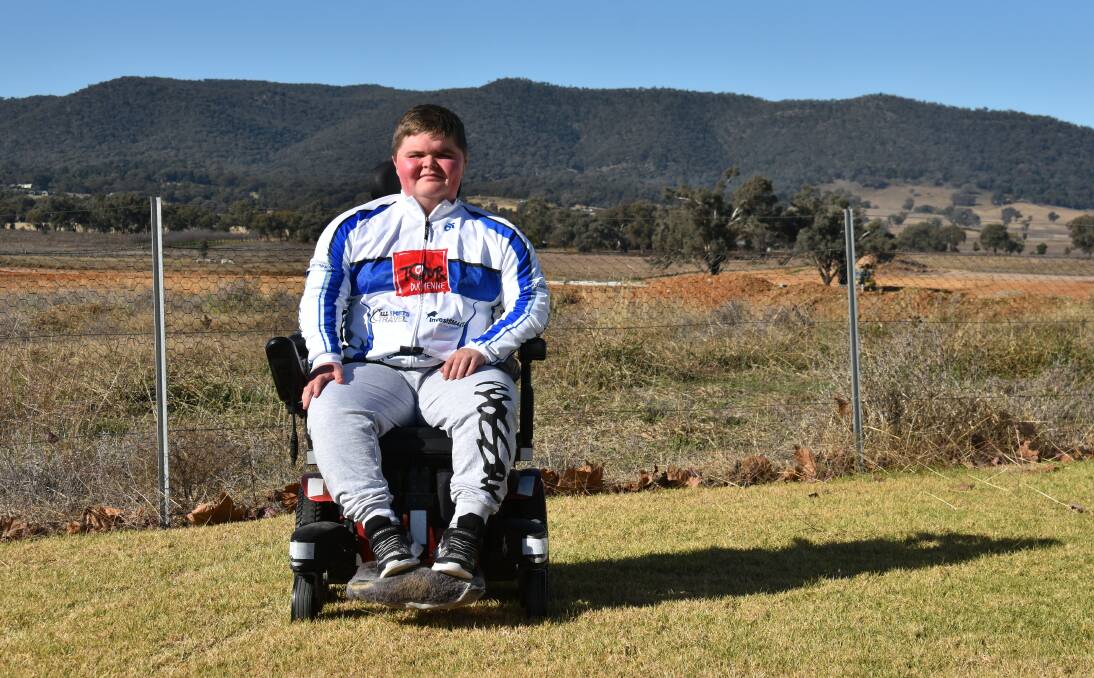 READY: James Thompson proudly wears a Tour Duchenne riding jacket in front of the vacant block of land he hopes will become a fully-serviced respite home.