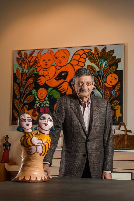 William Mora in his Richmond gallery, surrounded by his mother's artworks