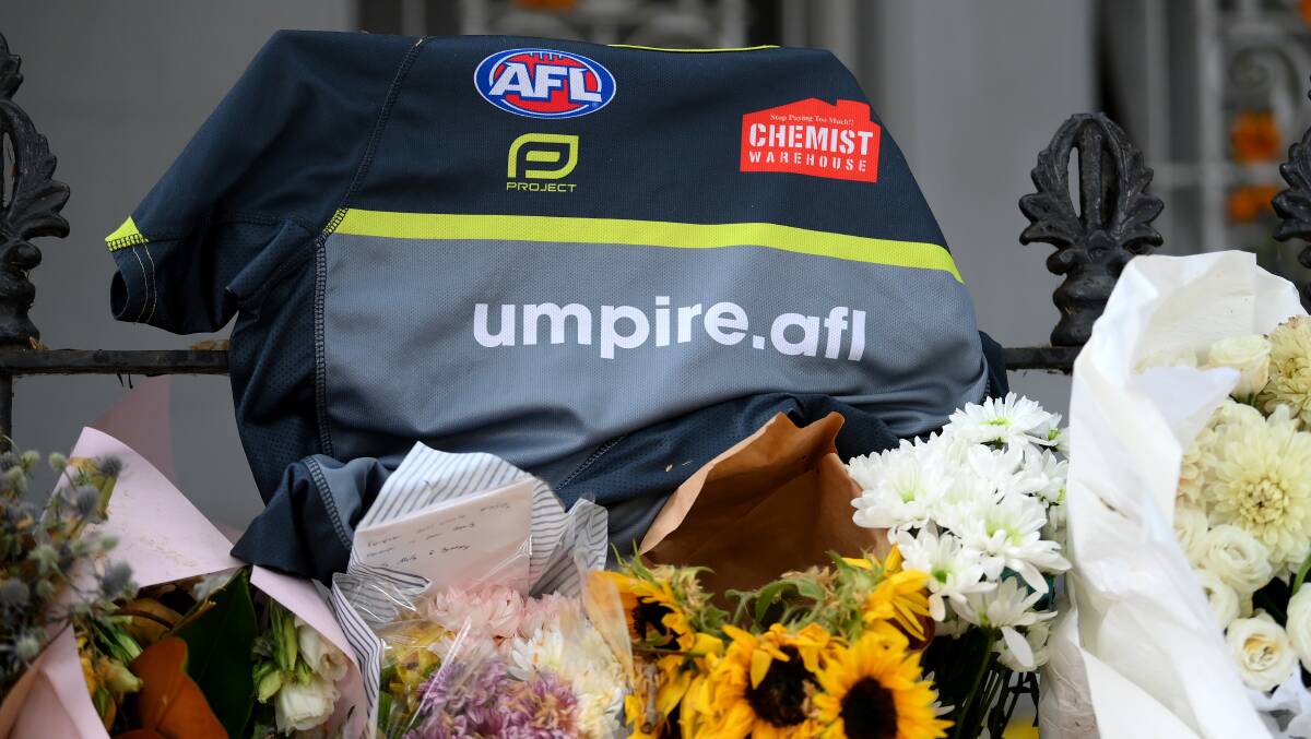 An AFL umpires guernsey and floral tributes are seen at the Paddington residence of Jesse Baird. (AAP Image/Bianca De Marchi)