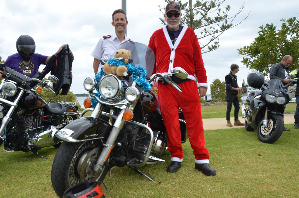 Captain Peter Gott from The Salvation Army with Mid North Coast Chapter of the Harley Owners Group activities officer Chris Dickson at the Salvation Army Toy Run. Bikers travelled from Laurieton Services Club to Westport Park to spread Christmas cheer. Picture by Emily Walker
