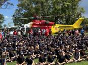 Wauchope Public School students gather around the Westpac Rescue Helicopter on the school's playing ground on Monday, November 27. Picture by WRHS